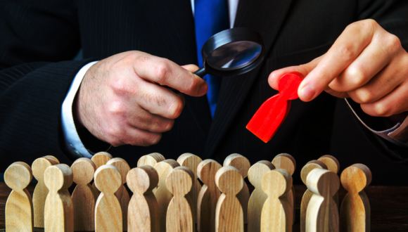 a man in a suit picks out the odd man out in a crowd