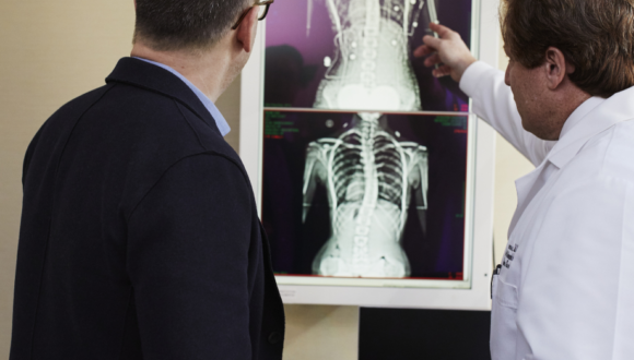 Two men analyzing x-rays