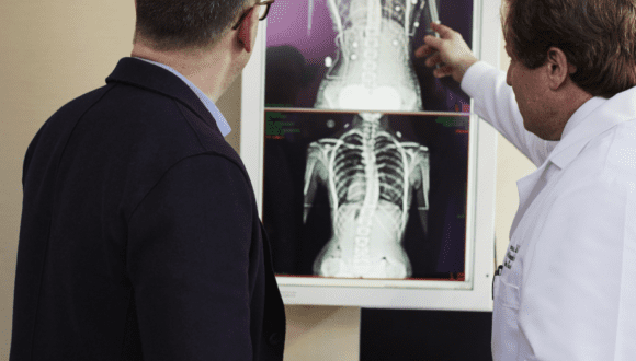 Two men analyzing x-rays