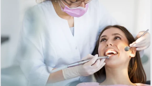 Dentist inspecting teeth representing green card options for foreign dentists