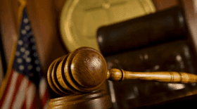 Gavel and courtroom setting, representing the H-1B proclamation lawsuit.